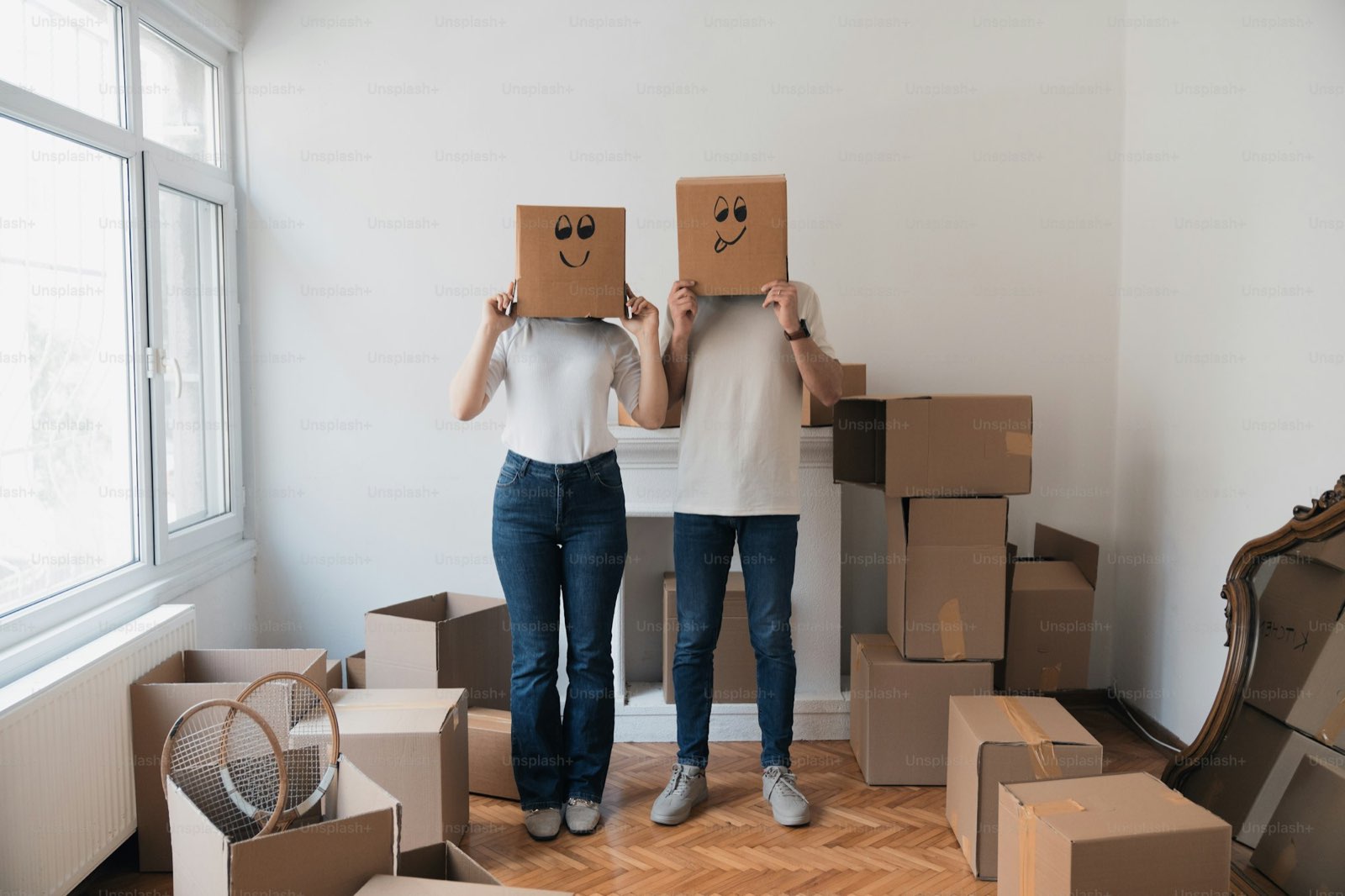 A couple having fun with moving boxes