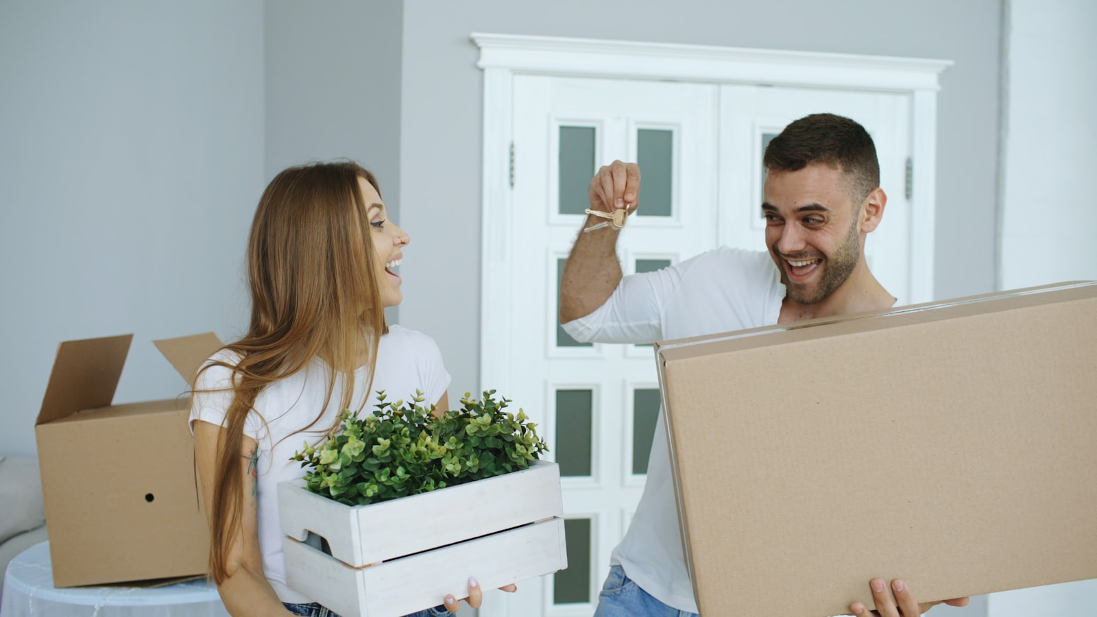 A couple celebrating with their new house keys on moving day