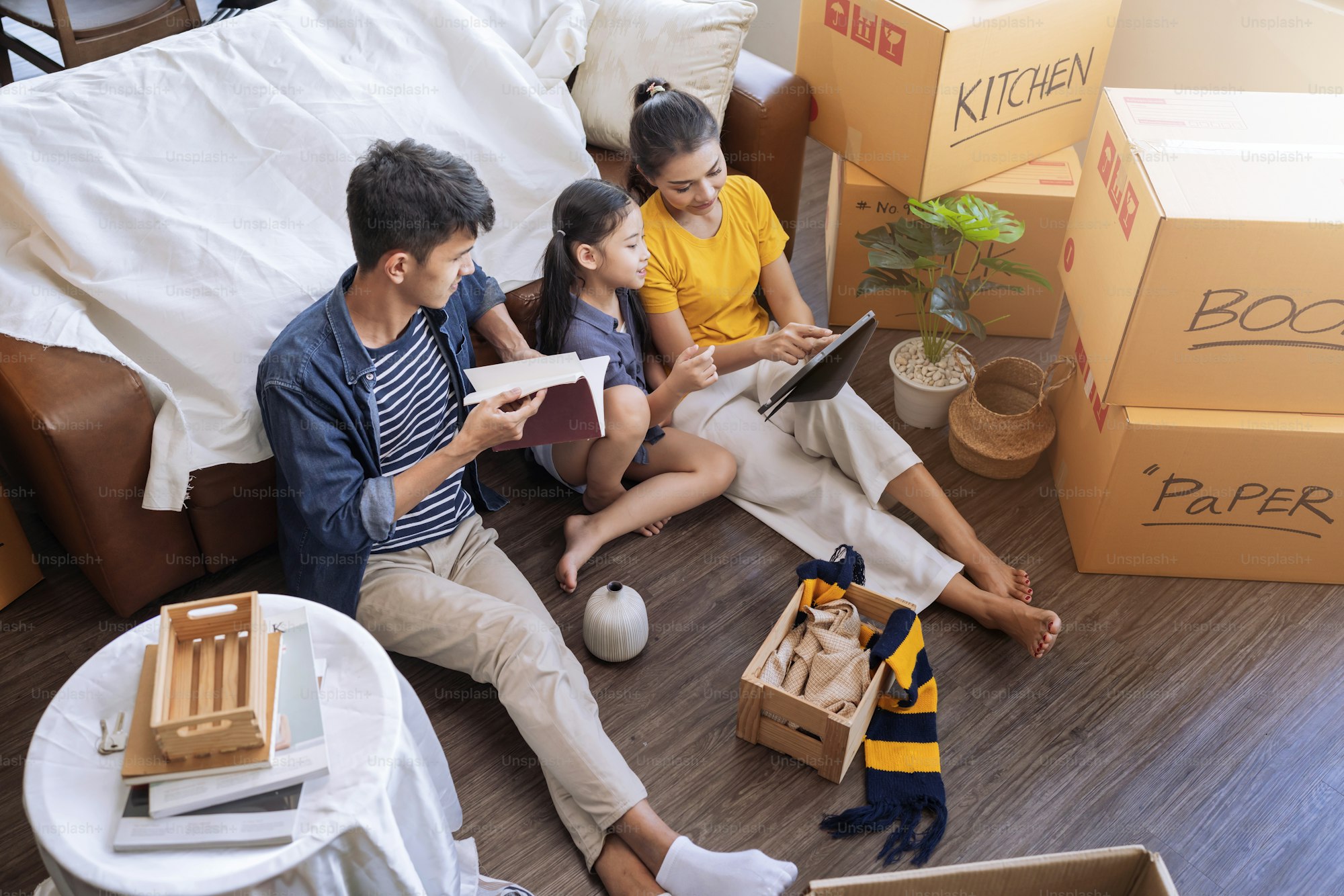 A family among moving boxes in their living room
