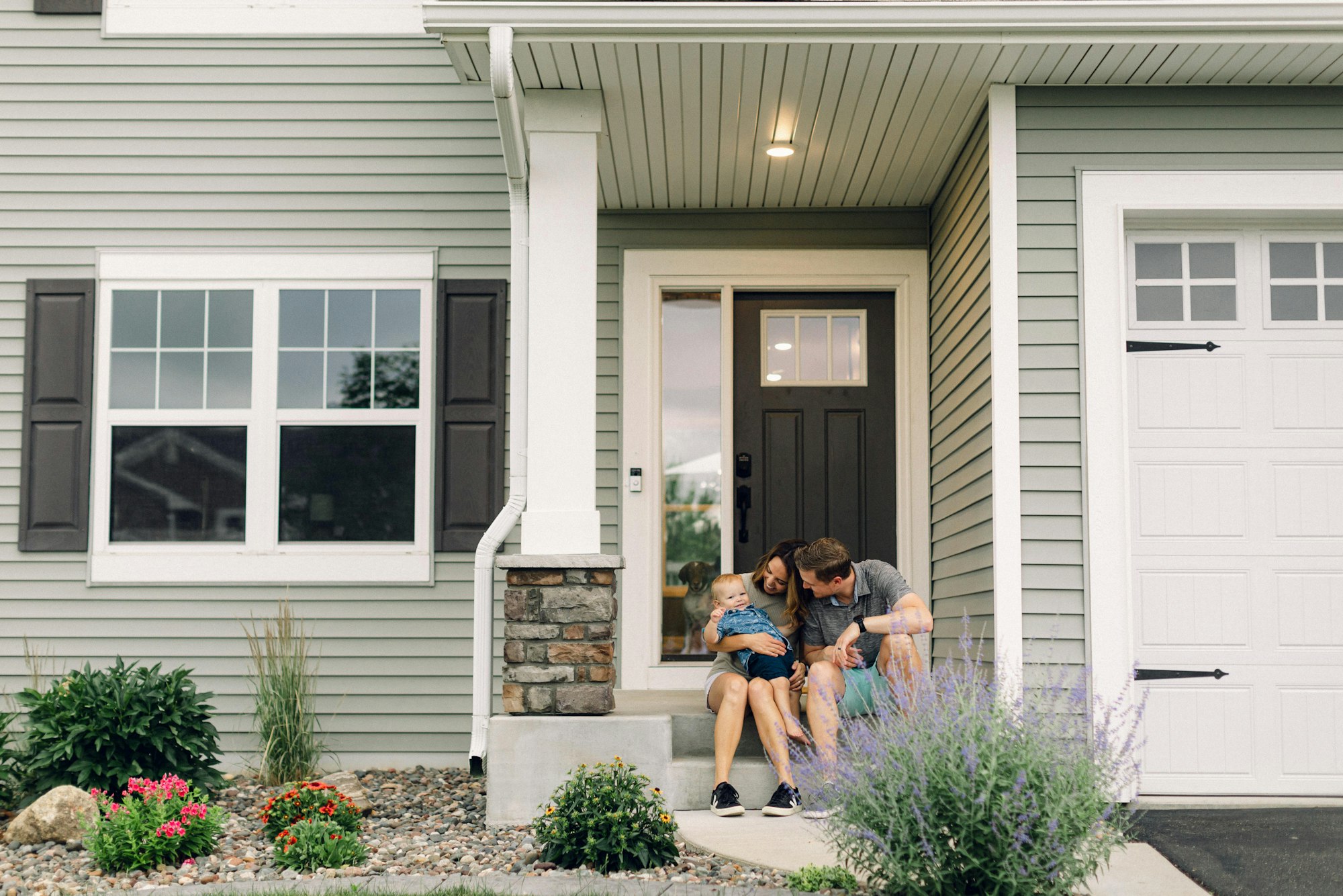 A family on the front steps of their home