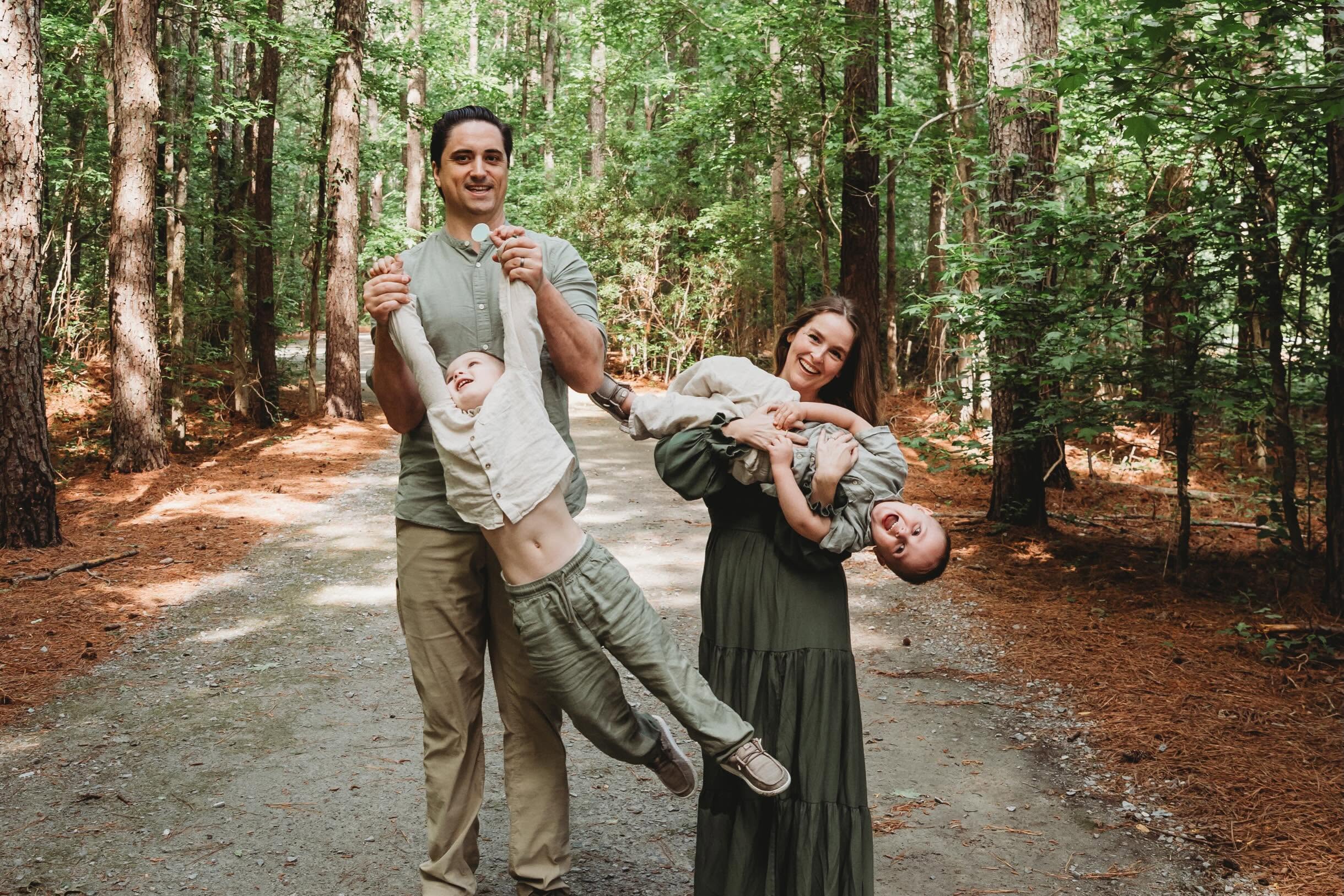 Lilli Driscoll and her family playing together on a wooded trail